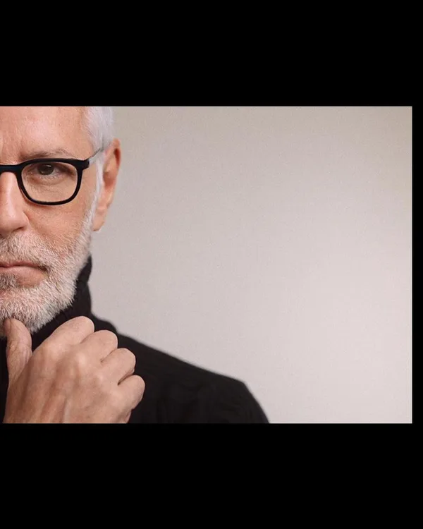 John Amedro close editorial portrait in glasses and black turtleneck