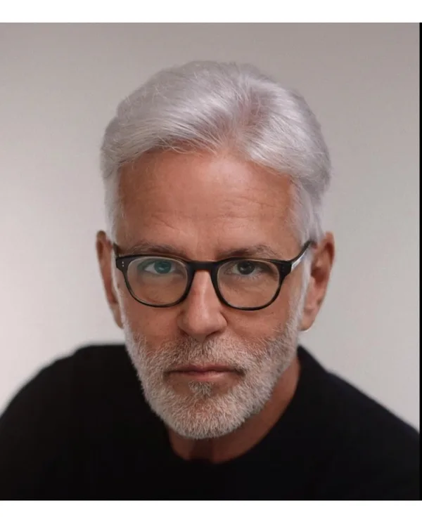 John Amedro primary headshot, silver hair and glasses, direct gaze